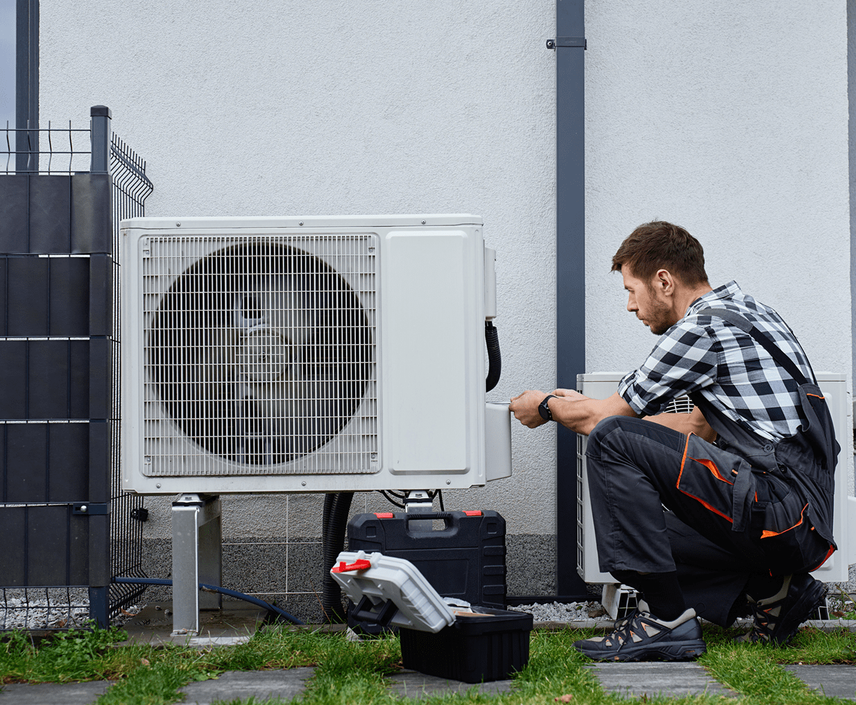 HVAC professional fixing AC system