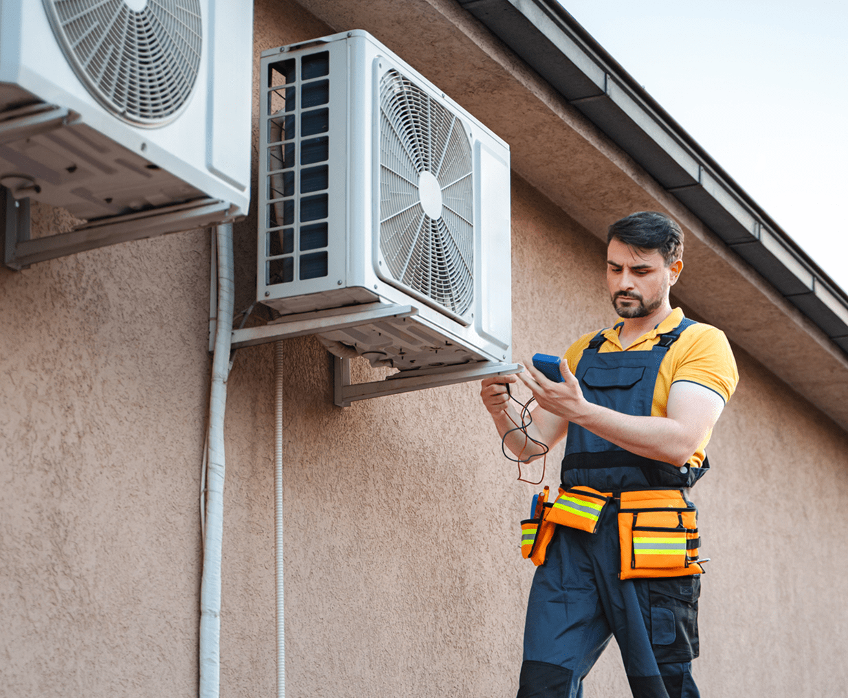 Technician inspecting air conditioning unit