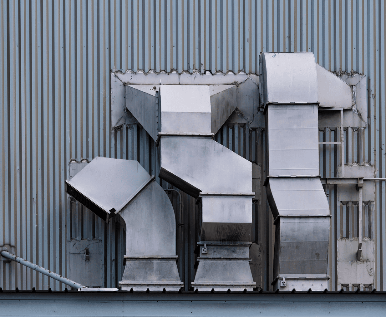 Industrial ventilation ducts on metal wall