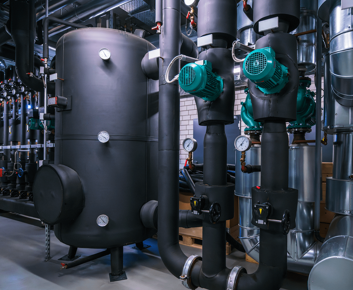 Black tank and green pumps in facility